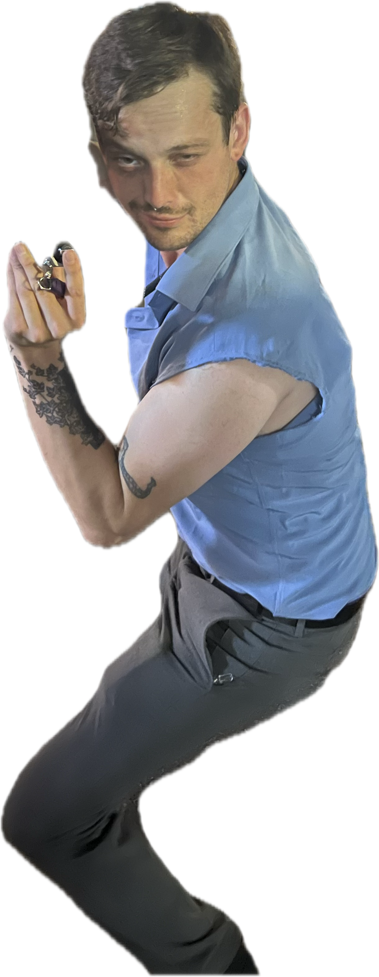 A man in a blue shirt striking a pose
